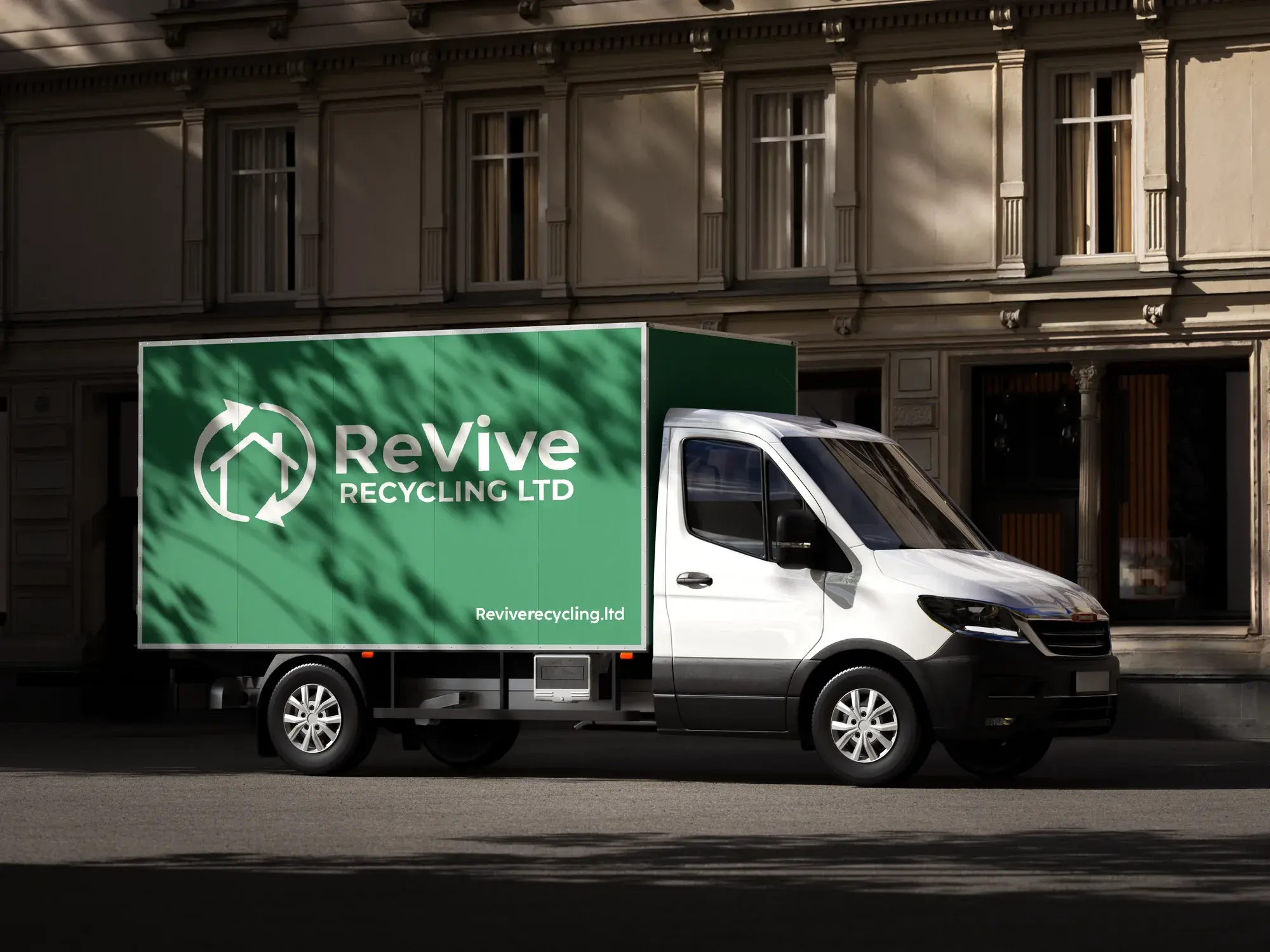 A ReVive Recycling Ltd branded box van parked on a town street